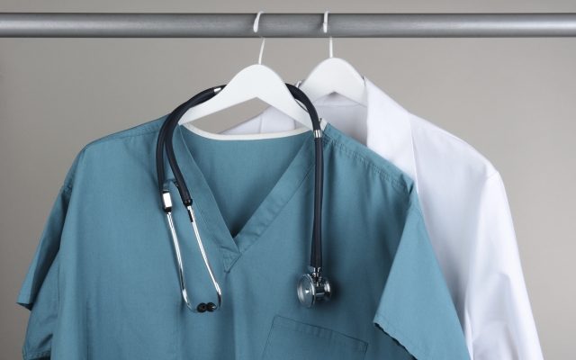 Scrubs with Stethoscope and Lab Coat on Hanger