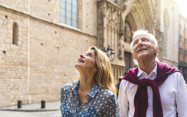 Senior couple of tourists visiting the old town in Barcelona